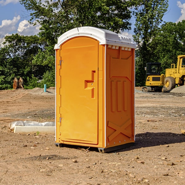 what is the cost difference between standard and deluxe portable restroom rentals in Holcomb